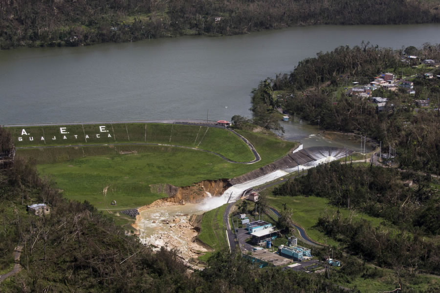 Water drains Saturday from the Guajataca Dam in Quebradillas, Puerto Rico. Officials rushed to evacuate people downstream of the failing dam, which was built around 1928.