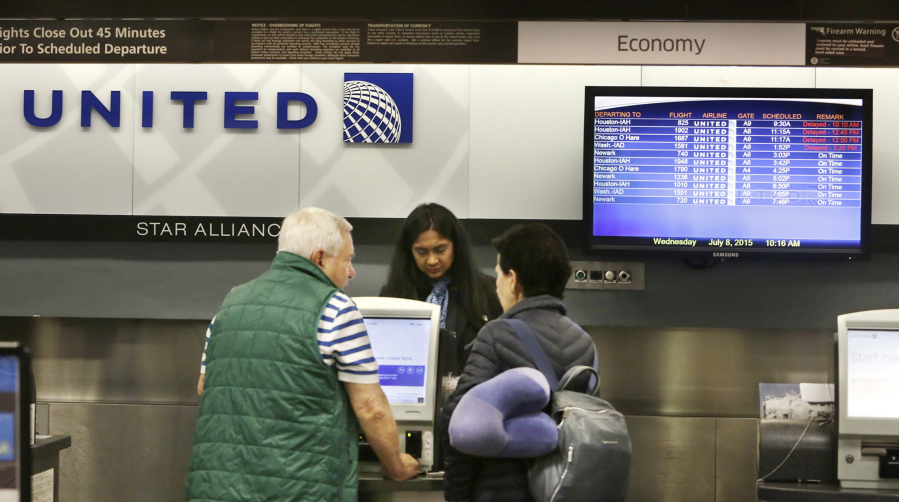 Passengers check into the United Airlines ticket counter at Tampa International Airport in 2015 in Tampa, Fla.