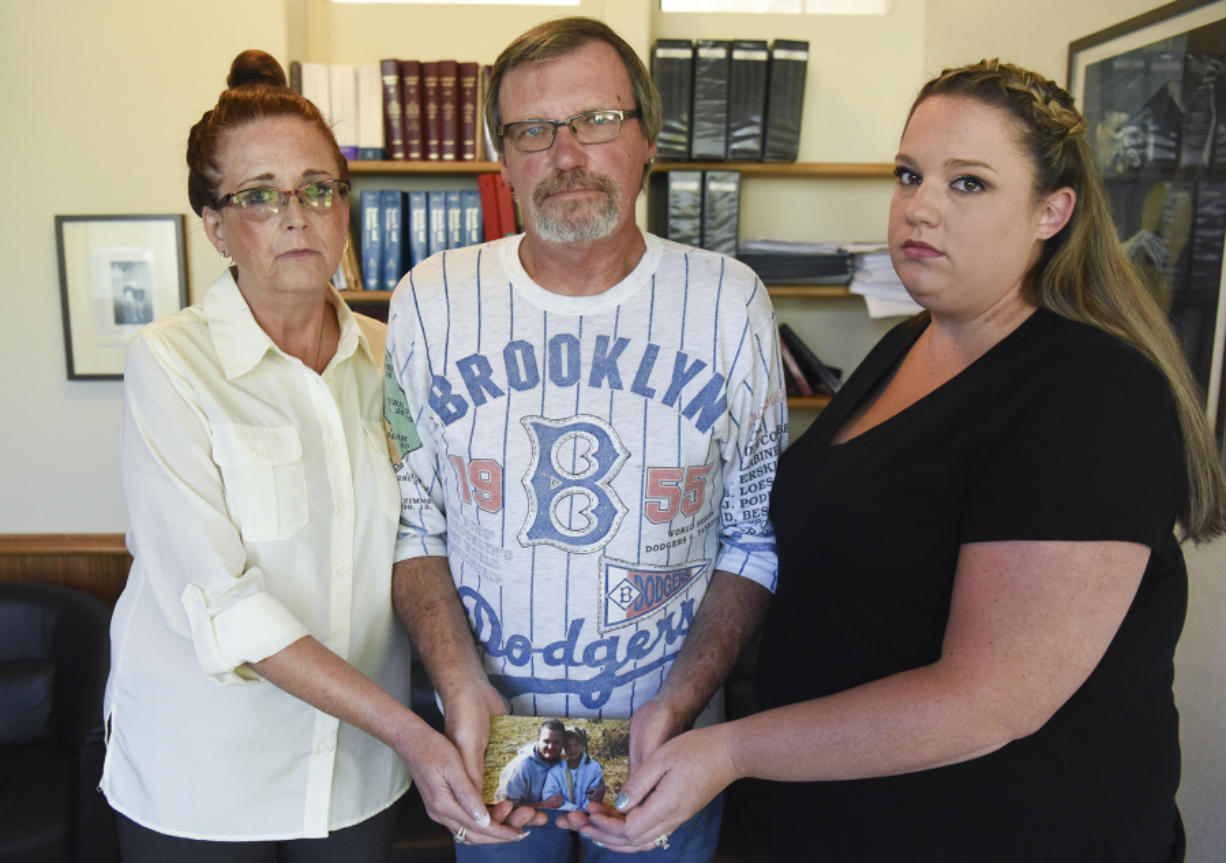 Mycheal Lynch’s stepmother Lila Fields, father Kim Lynch and sister Kelly Foster hold a photo of Mycheal with his niece. Mycheal Lynch was 32 in March 2015 when he died after a struggle in the Clark County Jail. Since his death, Lynch’s family has been working with attorneys Jack Green and Greg Ferguson to find answers and seek justice for their loved one.