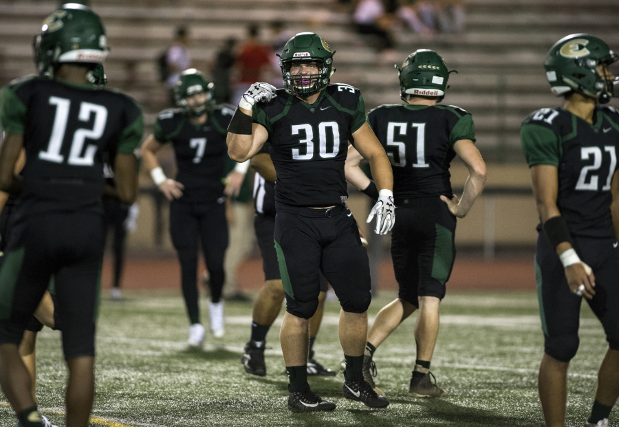 Evergreen’s Serge Rusnak (30) calls out to teammates before lining up for the snap during the game against Columbia River at Makenzie Stadium on Sept. 1, 2017.