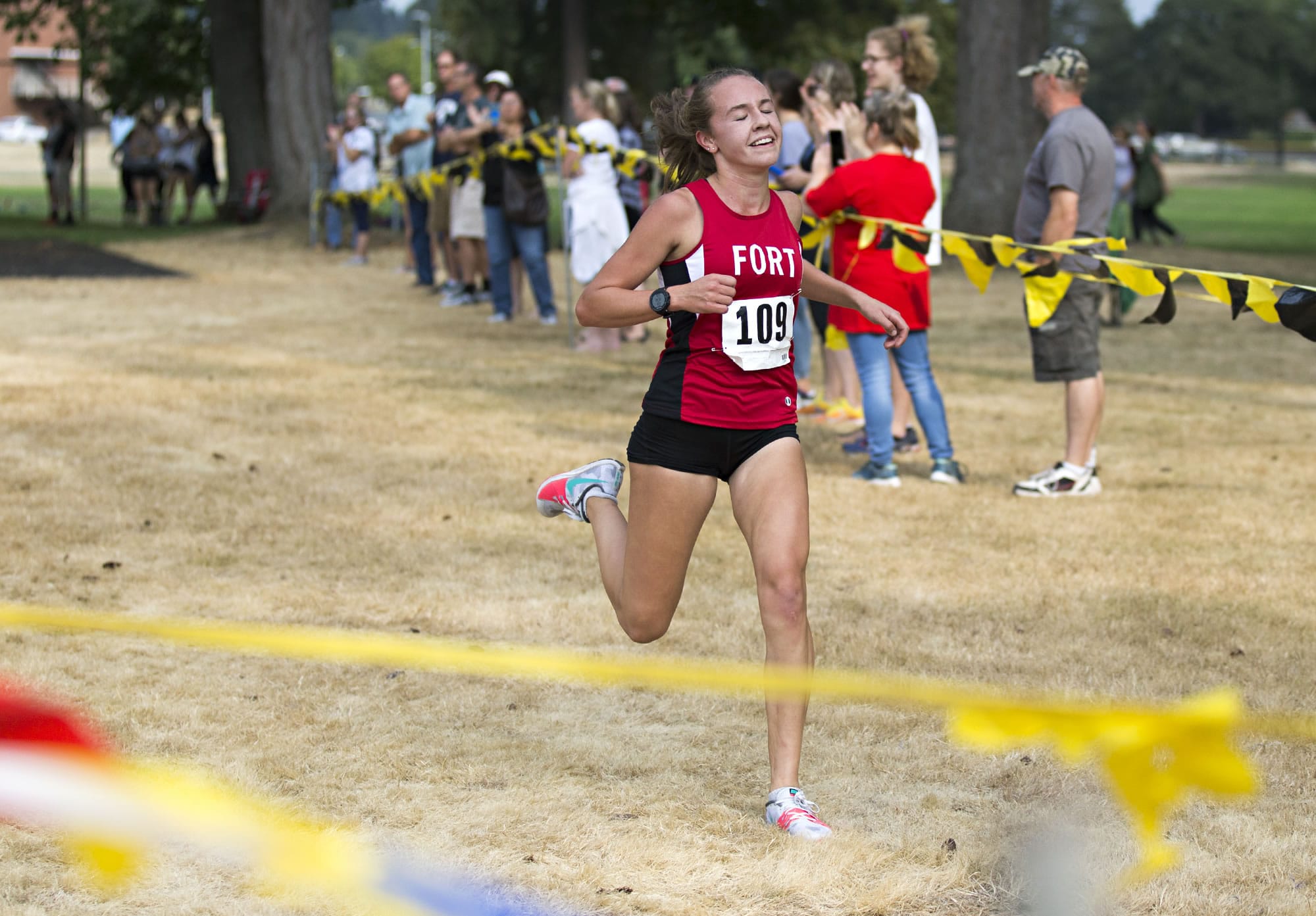 Fort Vancouver junior Emily Phelps (109) crosses the finish line with her eyes closed and a smile on her face in first place in the annual Run-A-Ree for varsity women's with a time of 18 minutes, 51 seconds at Hudson's Bay High School in Vancouver on Friday, Sept. 8, 2017.