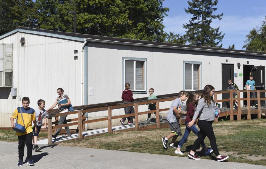 Sixth-grade students leave a portable at La Center Elementary School, where there are a total of 18 portable classrooms to help deal with the district’s growing population. The district will put a bond up for vote in February to build a new elementary or middle school to help deal with overcrowding.