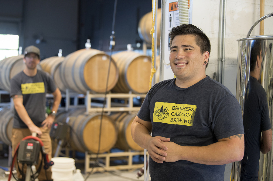 Matt Ellis, left, and Jason Bos discuss their experiences brewing beer at Brothers Cascadia Brewing in Vancouver.