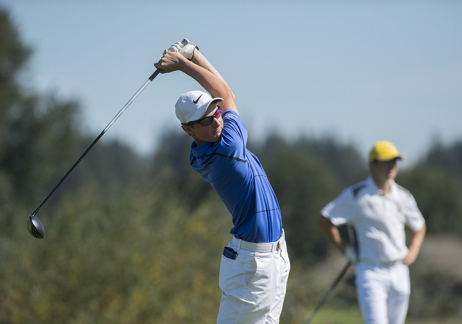 Graham Moody of Mountain View, left, tees off on the 12th hole as Keith Lobis of Union looks on during the Jeff Hudson Invitational High School Golf Tournament at Tri-Mountain Golf Course on Tuesday morning, Sept. 12, 2017.
