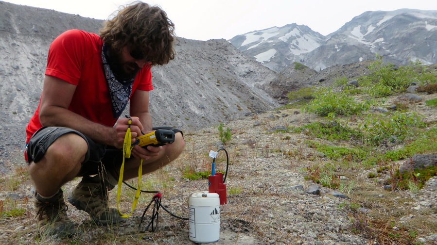 Steve Hanson from the University of New Mexico sits next to one of 140 seismometers placed on Mount St. Helens to examine very subtle activity below the surface. (U.S.