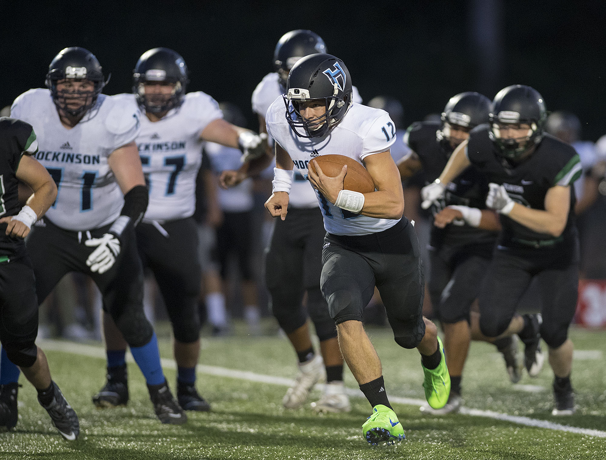 Hockinson's Canon Racanelli (12) breaks through the pack for yardage in the first quarter at Woodland High School on Friday night, Sept. 15, 2017.