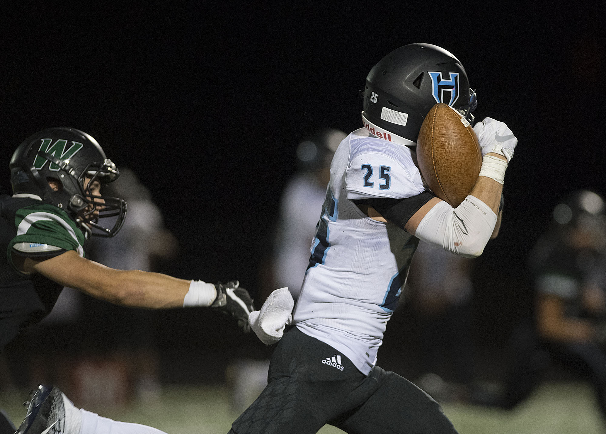 Hockinson's Matt Henry (25) is able to hang onto a pass as he makes his way downfield in the second quarter at Woodland High School on Friday night, Sept. 15, 2017.