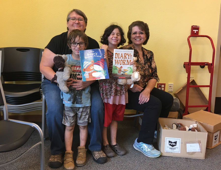 Suzanne Haidri, a teacher from Cascade Locks, Ore., and Jeanean Burgon, senior library assistant, with Cascade Locks siblings Lonnie and Luetta Bardes at the Stevenson evacuation shelter.