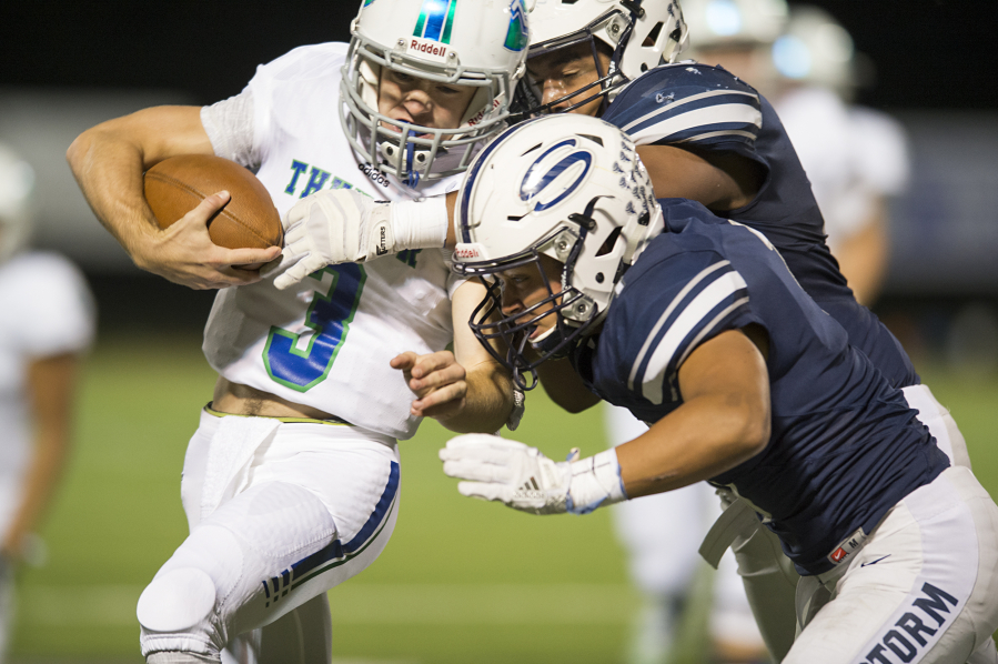 Mountain View’s Glen Perry Jr. (3) is hit by Skyview’s Jayden Chatman (88) and Angelo Sarchi (1). Perry left the game in the second quarter with a knee and ankle injury.