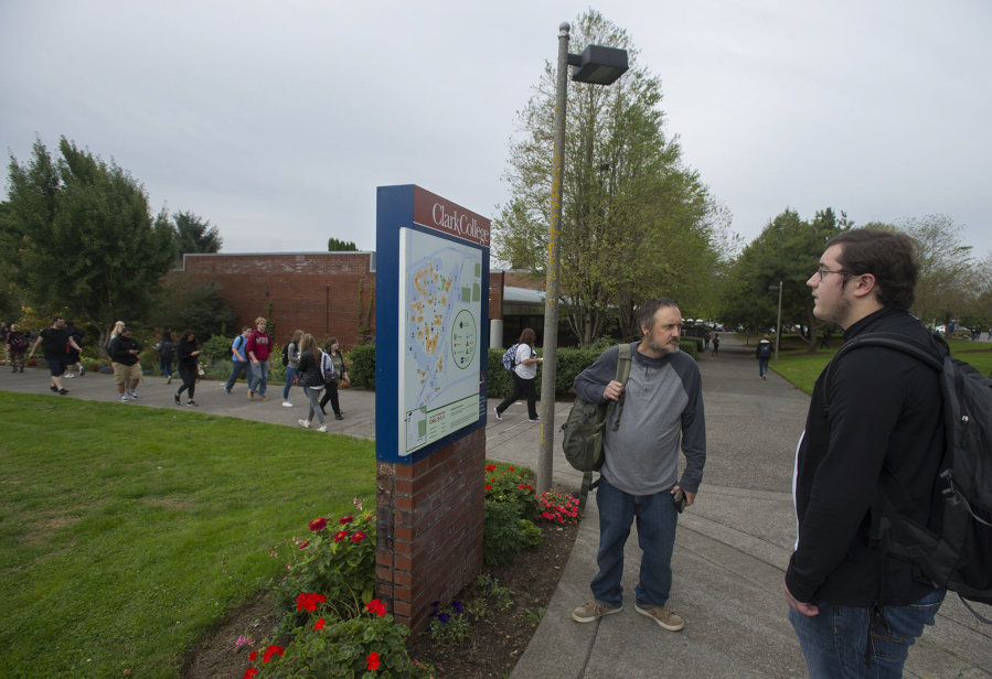 Clark College student Chad Hatch, in gray, of Battle Ground and Aidan Brinkman, a Running Start student from Hockinson, pause to get directions while finding their way around campus during the first day of classes late Monday morning. About 12,000 students are enrolled at the college this quarter.