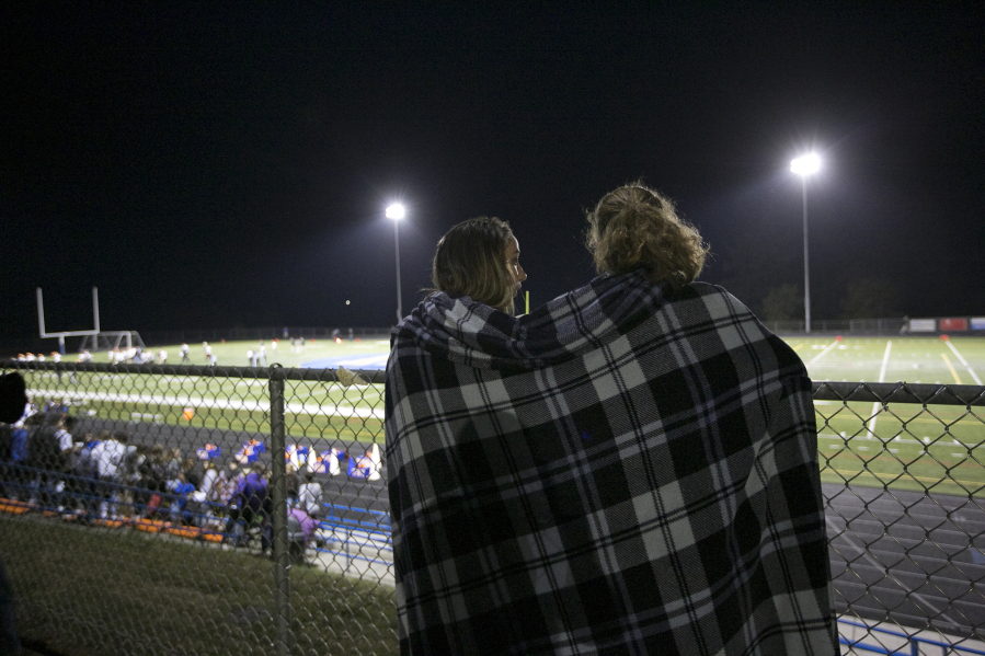 Spectators share a blanket on a fall night at a game in Ridgefield Friday September 29, 2016. Washougal squared off with Ridgefield.