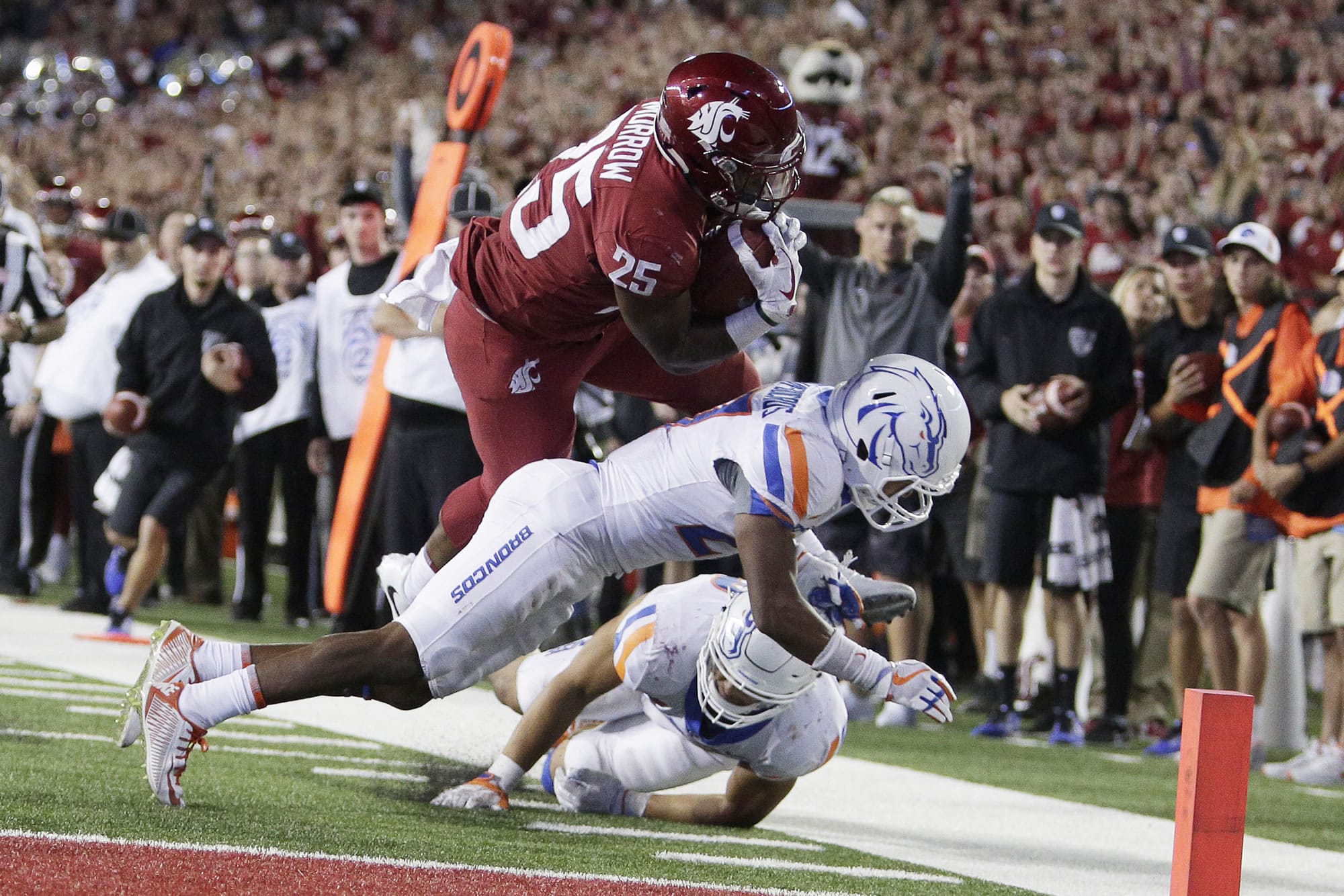 Washington State running back Jamal Morrow (25) dives for the game winning touchdown over Boise State cornerback Reid Harrison-Ducros, center, and linebacker Tyson Maeva during third overtime at Pullman, on Saturday, Sept. 9, 2017. Washington State won 47-44.