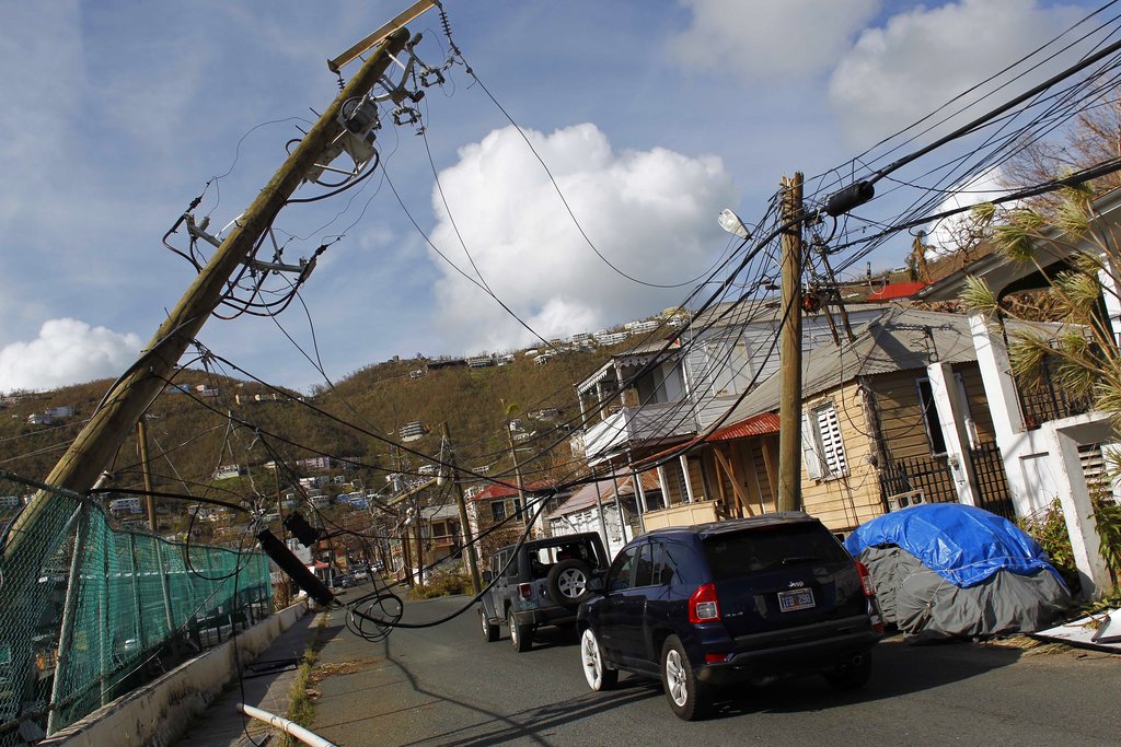 Power lines are damaged after the passage of Hurricane Irma in Charlotte Amalie, St. Thomas, U.S. Virgin Islands, Sunday, Sept. 10, 2017.  The storm ravaged such lush resort islands as St. Martin, St. Barts, St. Thomas, Barbuda and Anguilla.