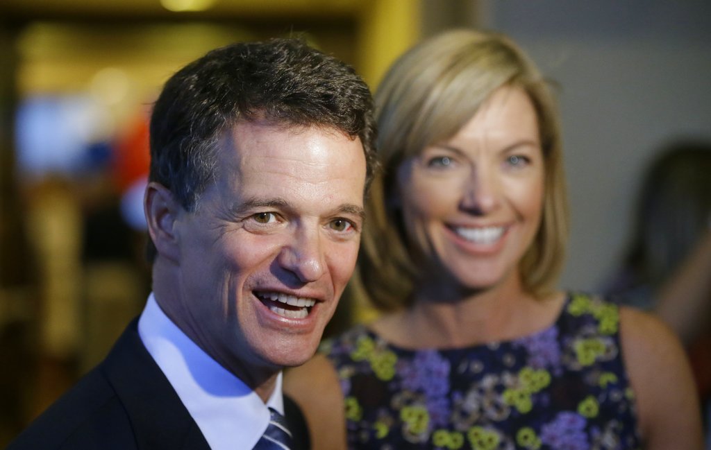 FILE - In this Aug. 5, 2014 file photo, Republican David Trott, a candidate for Michigan's 11th congressional district, stands next to his wife, Kappy, during an interview at his election night party in Troy, Mich. In a statement Monday, Sept. 11, 2017, Trott, R-Mich., says he will not seek re-election.