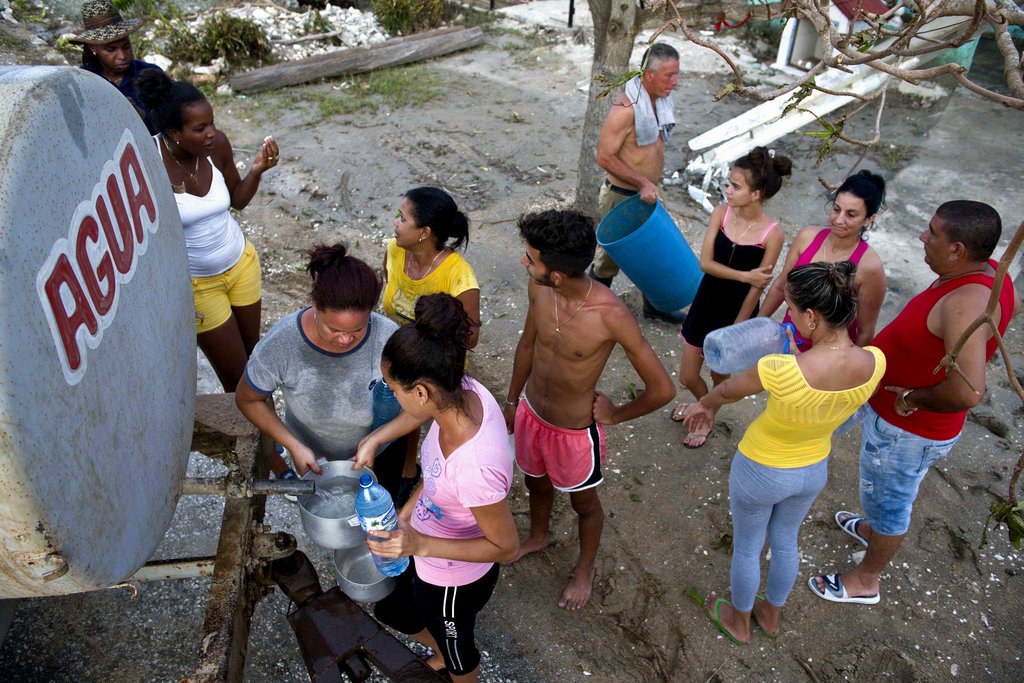Locals affected by Hurricane Irma line up to collect drinking water in Isabela de Sagua, Cuba, Monday, Sept. 11, 2017. The powerful storm ripped roofs off houses, collapsed buildings and flooded hundreds of thousands of coastline after cutting a trail of destruction across the Caribbean. Cuban officials warned residents to watch for even more flooding over the next few days.