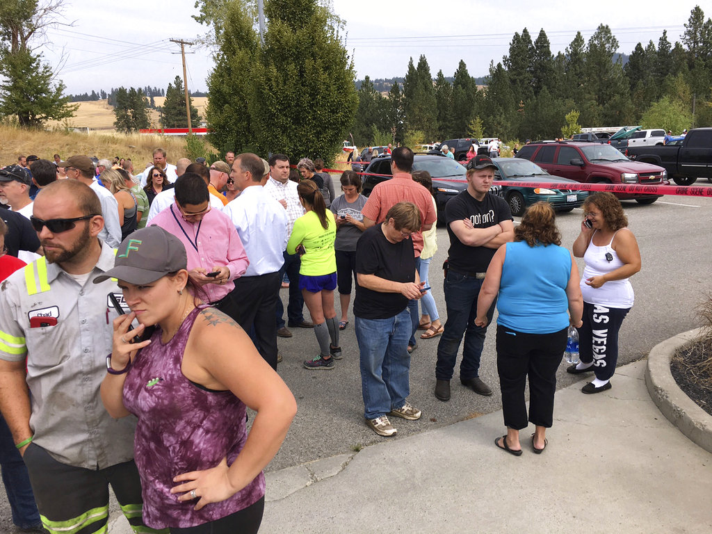 Parents gather in the parking lot behind Freeman High School in Rockford, Wash. to wait for their kids, after a deadly shooting at the high school Wednesday, Sept. 13, 2017.