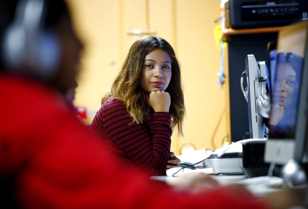 FILE - In this Nov. 17, 2016 file photo, Andrea Aguilera sits at the Erie Neighborhood House in Chicago. Aguilera was illegally brought across the Mexican border at age 4 and now is is a junior at Dominican University in suburban Chicago. She is one of nearly 800,000 young immigrants who received a reprieve from deportation under the Obama-era program known as Deferred Action for Childhood Arrivals, or DACA. Aguilera's DACA expires in July 2019. (AP Photo/Nam Y.