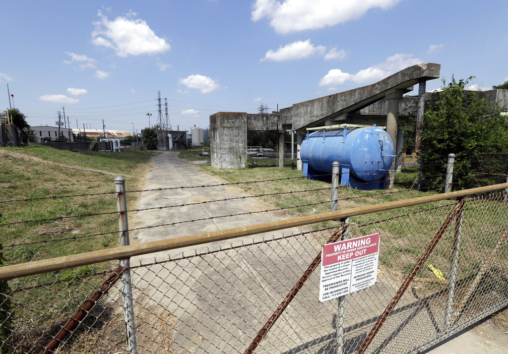 A gate at the U.S. Oil Recovery Superfund site is shown Thursday, Sept. 14, 2017, in Pasadena, Texas, where three tanks once used to store toxic waste were flooded during Hurricane Harvey. The Environmental Protection Agency says it has found no evidence that toxins washed off the site, but is still assessing damage.
