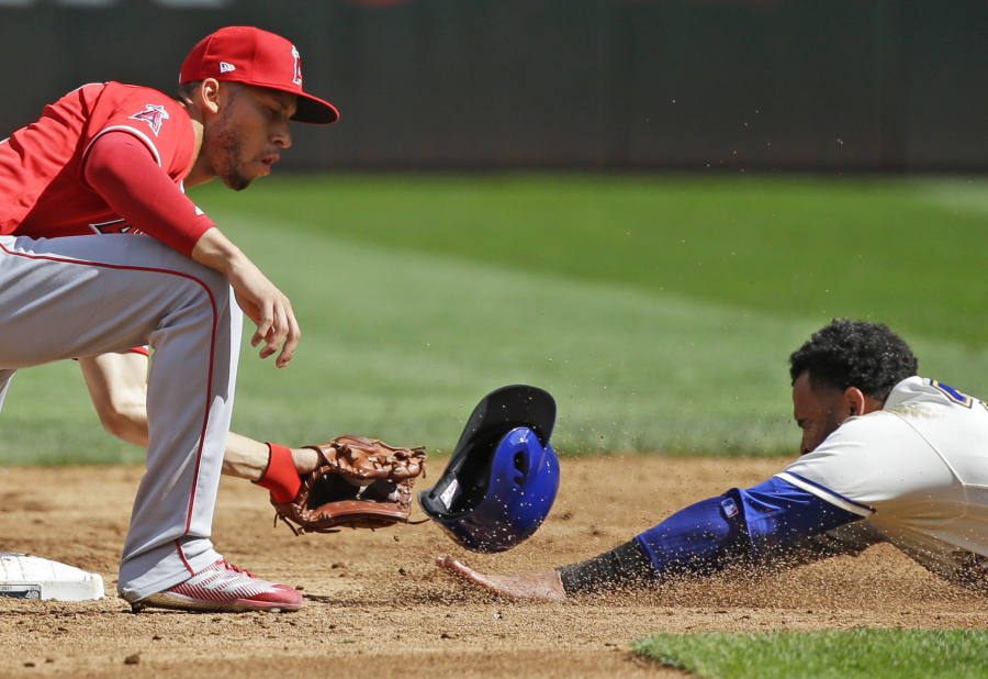 Seattle Mariners’ Nelson Cruz, right, is out trying to steal second as Los Angeles Angels shortstop Andrelton Simmons, left, makes the pickoff catch and the tag in the third inning of a baseball game, Sunday, Sept. 10, 2017, in Seattle. (AP Photo/Ted S.