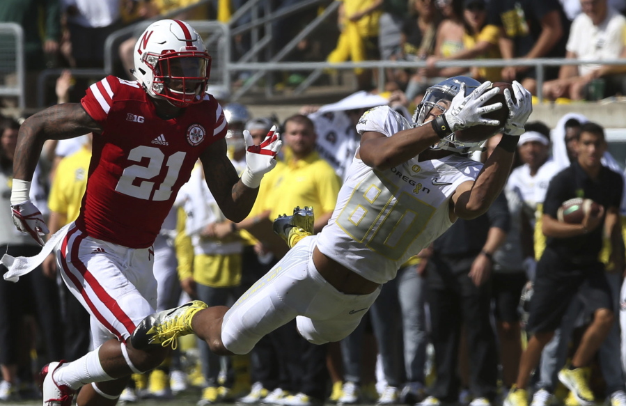 Oregon wide receiver Johnny Johnson III, right, pulls down a diving catch ahead of Nebraska of defensive back Lamar Jackson during the second quarter of an NCAA college football game Saturday, Sept. 9, 2017, in Eugene, Ore.