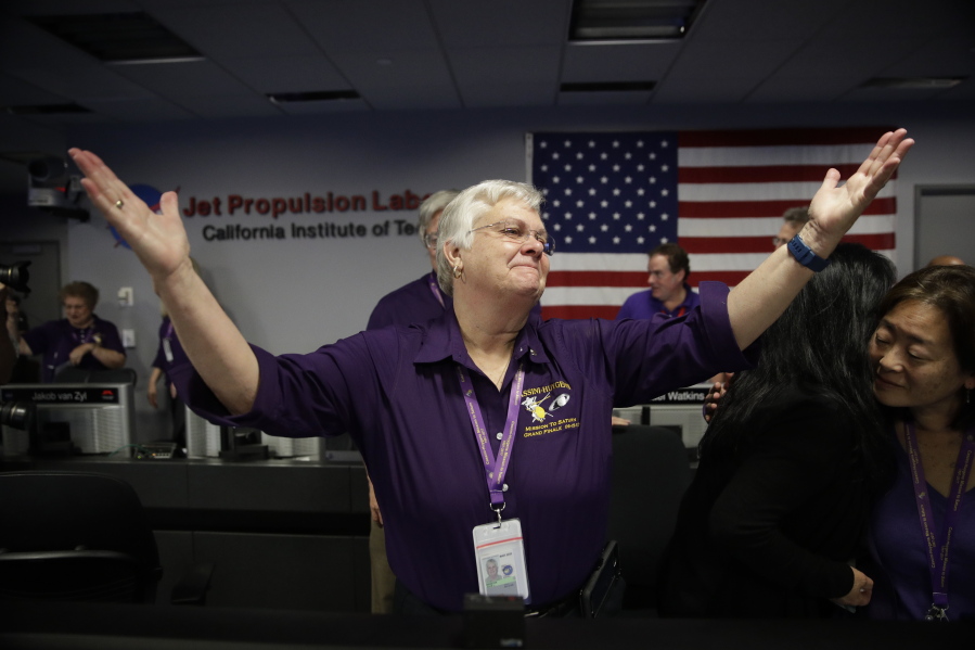 Flight director Julie Webster reacts in mission control at NASA’s Jet Propulsion Laboratory after confirmation of Cassini’s demise Friday, Sept. 15, 2017, in Pasadena , Calif. Cassini disintegrated in the skies above Saturn early Friday, following a remarkable journey of 20 years. (AP Photo/Jae C.