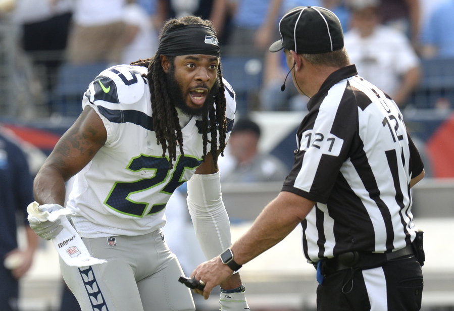 Seattle Seahawks cornerback Richard Sherman (25) argues a penalty call with umpire Paul King (121) in the first half of an NFL football game against the Tennessee Titans Sunday, Sept. 24, 2017, in Nashville, Tenn.