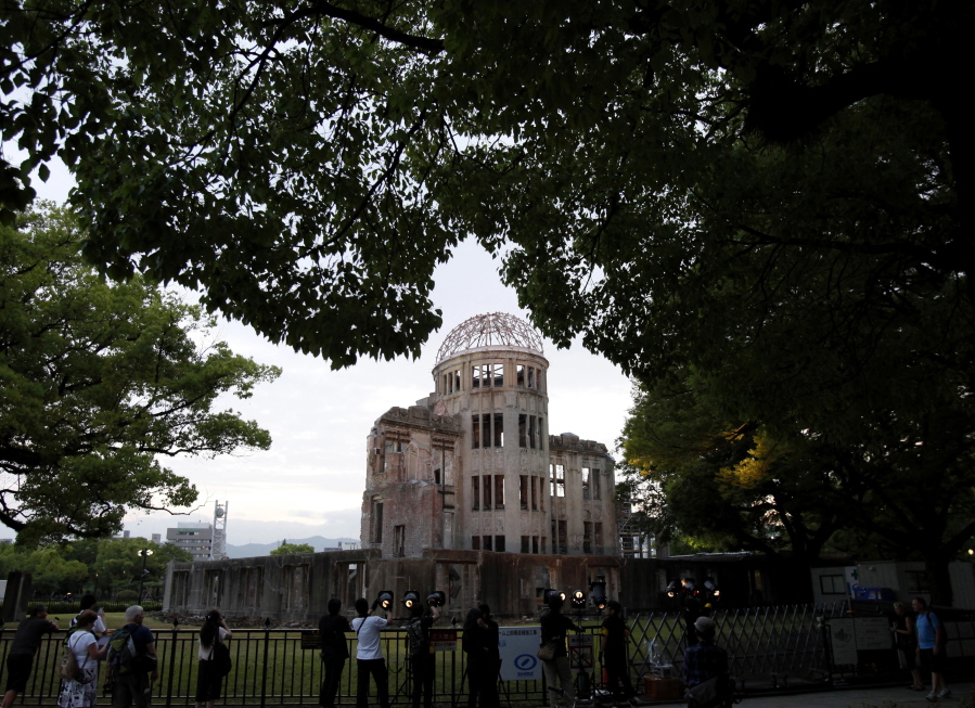People gather around the gutted Atomic Bomb Dome at the Hiroshima Peace Memorial Park in Hiroshima, southwestern Japan. Japan, despite Hiroshima and Nagasaki and it’s “never again” to use of nuclear weapons, joined the nuclear powers and NATO in not signing this treaty. Because It’s a close U.S. ally and it’s protected by the U.S. nuclear umbrella.
