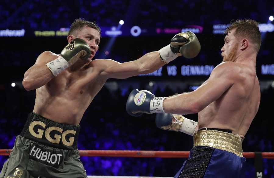 Gennady Golovkin, left, fights Canelo Alvarez during a middleweight title fight Saturday, Sept. 16, 2017, in Las Vegas.