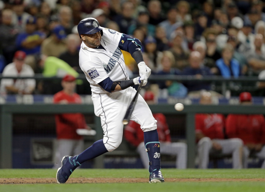 Seattle Mariners’ Nelson Cruz hits a three-run home run odd Los Angeles Angels’ Eduardo Paredes during the fourth inning of a baseball game Saturday, Sept. 9, 2017, in Seattle.