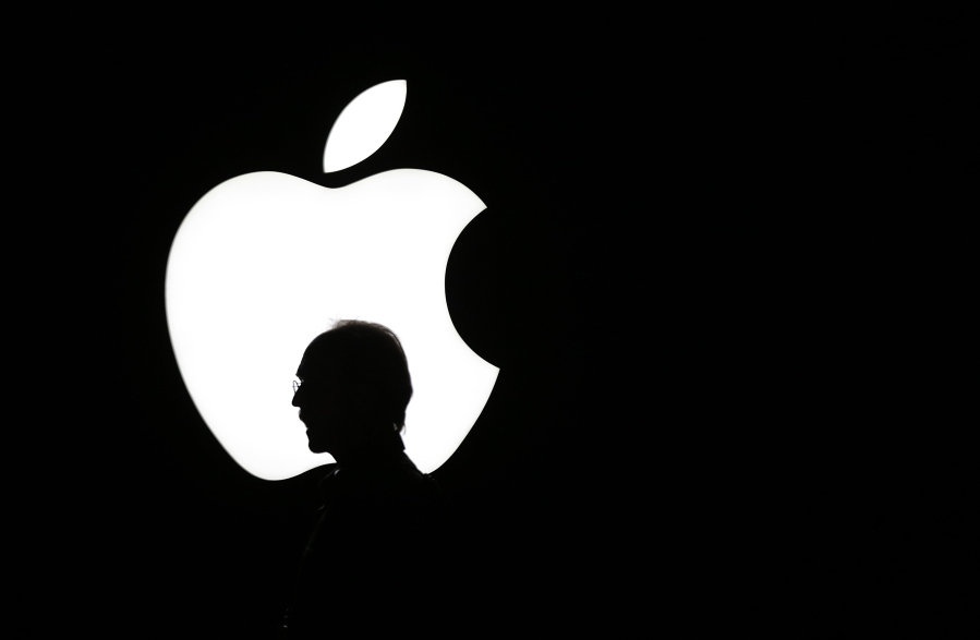 FILE - In this Sept. 9, 2015 file photo, a man walks past the Apple logo during a product display for Apple TV following an Apple event in San Francisco. Television is one of the few screens that has Apple hasn’t conquered, but that may soon change.