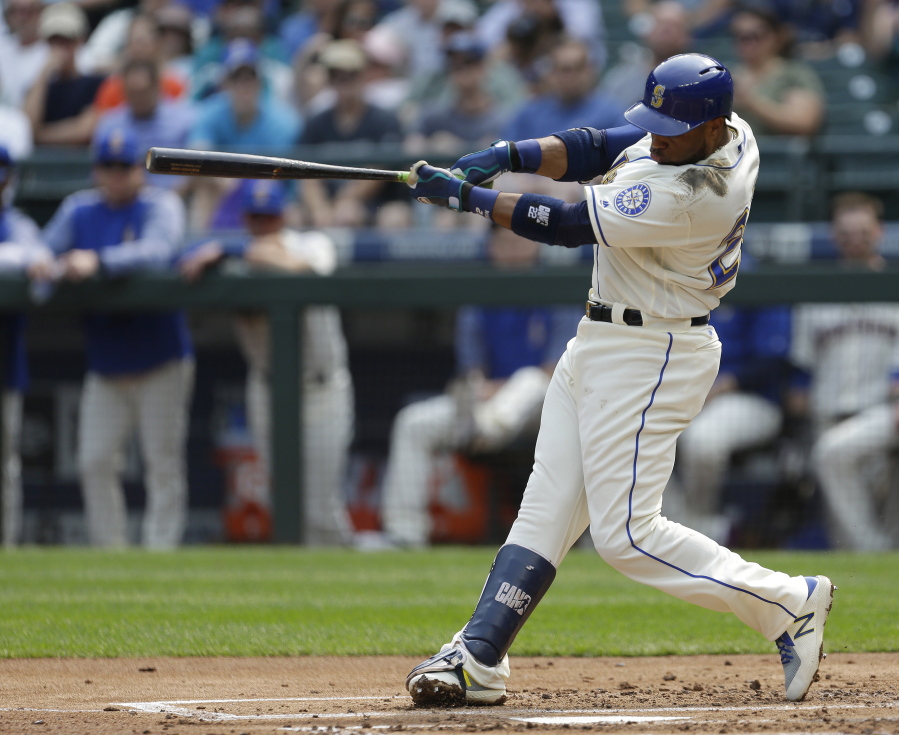 Seattle Mariners’ Robinson Cano hits a two-run home run to score Jean Segura in the first inning of a baseball game against the Oakland Athletics, Sunday, Sept. 3, 2017, in Seattle. (AP Photo/Ted S.