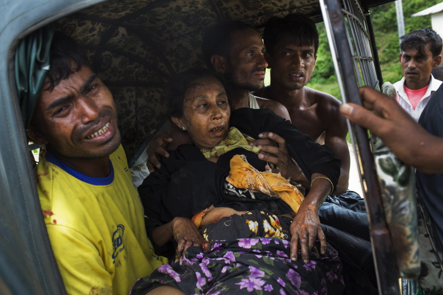 An injured elderly woman and her relatives rush to a hospital on an autorickshaw, near the border town of Kutupalong, Bangladesh, Monday, Sept. 4, 2017. The Rohingya woman encountered a landmine that blew off the right leg while trying to cross into Bangladesh.