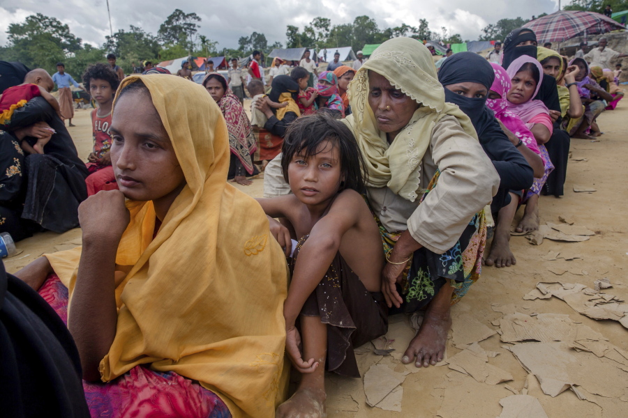 Rohingya Muslims, who recently crossed over from Myanmar into Bangladesh, wait for their turn to receive food aid near Balukhali refugee camp, Bangladesh, on Friday. Thousands of Rohingya are continuing to stream across the border, with U.N. officials and others demanding that Myanmar halt what they describe as a campaign of ethnic cleansing that has driven nearly 400,000 Rohingya to flee in the past three weeks.