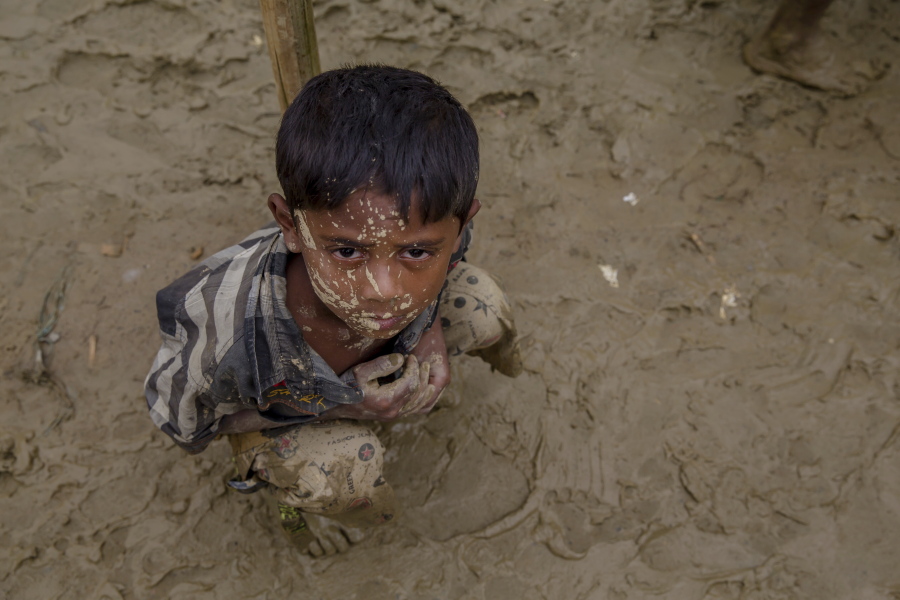 A Rohingya boy who fled to Bangladesh from Myanmar waits during an aid distribution Thursday near Balukhali refugee camp in Bangladesh.