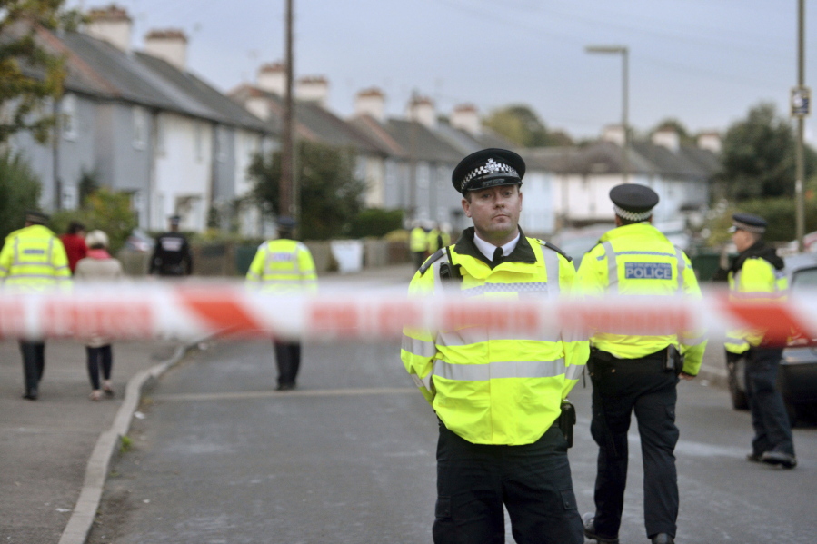 Police officers work Saturday near a property in Sunbury-on-Thames, southwest London, as part of the investigation into Friday’s Parsons Green bombing.