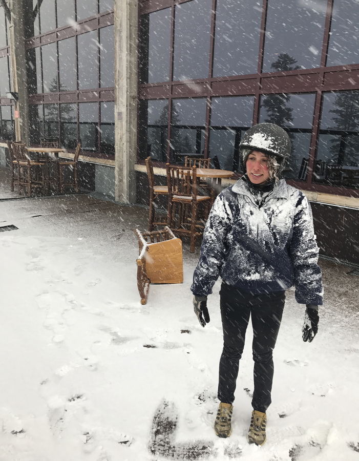 In this image provided by Northstar California, Jessie Hall, an employee at the Northstar California Resort looks out at the first snow of the season Thursday, Sept. 21, 2017, in Truckee, Calif. Snow is falling in the Sierra Nevada on the last day of summer, dusting hills and ski resorts with fresh snow and stoking excitement for an early skiing season. Forecasters say a rare cool weather system moving south from Oregon is bringing mountain rain and snow showers to the Sierra Thursday. Warmer and drier weather is expected by the weekend.