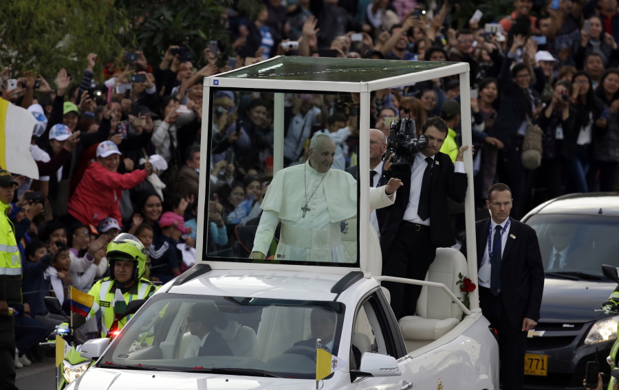 Pope Francis greets the crowd from the popemobile as he rides from the airport to the Nunciatura, after arriving to Bogota, Colombia, Wednesday, Sept. 6, 2017. Pope Francis has arrived in Colombia for a five-day visit.