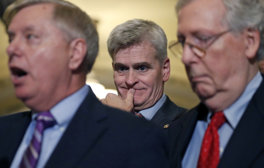 Sen. Bill Cassidy, R-La., center, listens as Sen. Lindsey Graham, R-S.C., left, speaks, accompanied by Senate Majority Leader Mitch McConnell of Ky., on Capitol Hill on Tuesday in Washington.