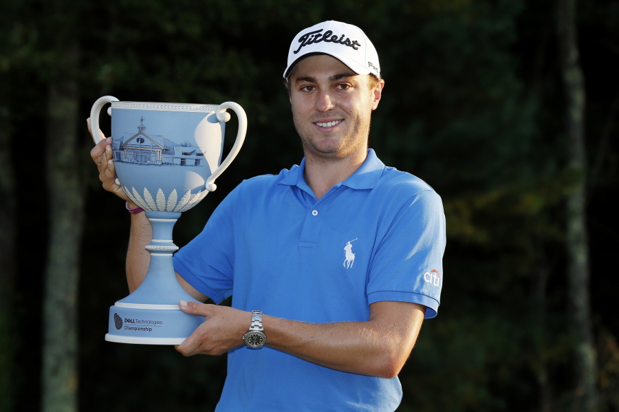 Justin Thomas holds the trophy after winning the Dell Technologies Championship golf tournament at TPC Boston in Norton, Mass., Monday, Sept. 4, 2017.