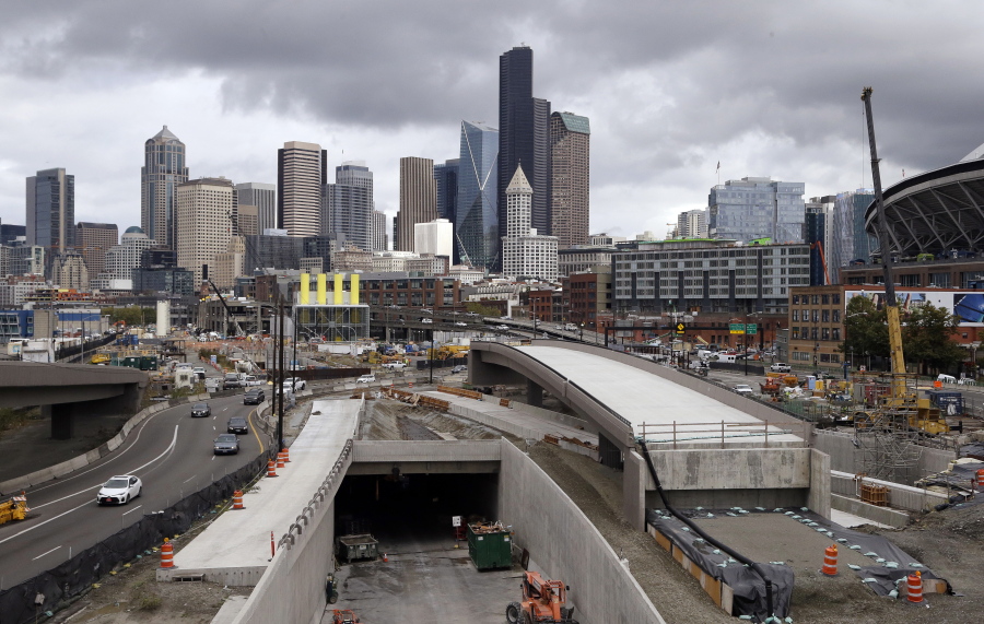 A portion of a new offramp for Highway 99 in downtown Seattle, center right, is completed and sits Tuesday adjacent to the entrance for northbound traffic into the Highway 99 tunnel still under construction. The offramp has a new type of column that flexes when the ground shakes in an earthquake, then snaps back to its original position.