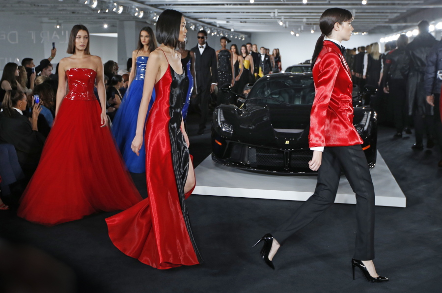 Models walk the runway in front of Ralph Lauren’s car collection in The Garage at the Ralph Lauren fashion show during Fashion Week, Tuesday, Sept. 12, 2017, in Bedford, NY.