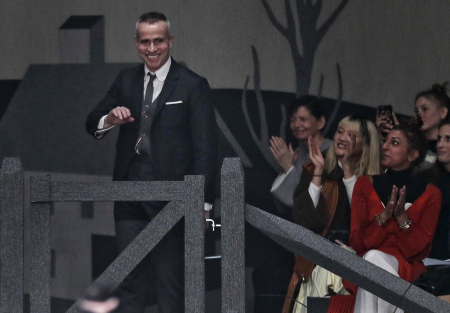 FILE - In this Wednesday, Feb. 15, 2017, file photo, designer Thom Browne acknowledges applause at the Thom Browne collection runway show during Fashion Week, in New York. The New York fashion world gathers Wednesday, Sept. 6, to honor designer Browne with the annual Couture Council Award for Artistry of Fashion from the Fashion Institute of Technology. Browne, who regularly puts on the most fascinating, theatrically stunning shows in all of Fashion Week, won’t be showing here: He’s moving his women’s shows to Paris, where he already shows his menswear.