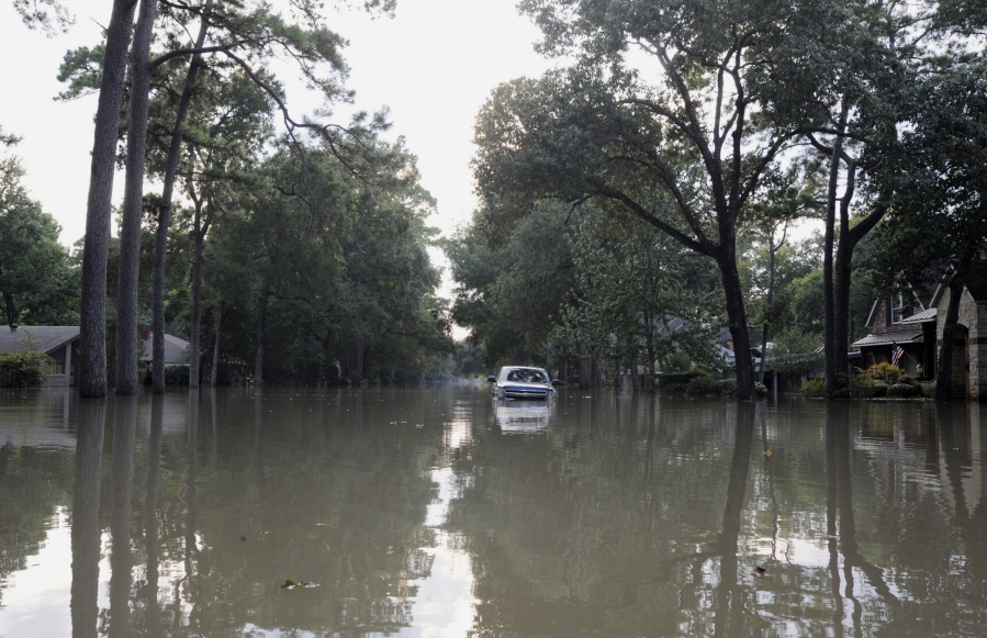 A pickup truck gets stranded on a street in a flooded neighborhood west of downtown Houston on Sunday. The city has ordered a mandatory evacuation of flooded-out homes in the area, but people are still retrieving belongings from homes that have been standing in water for days.