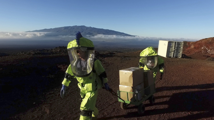 Crew members of Mission V, walk up hill with a cart next to the university’s facility Hawaii Space Exploration Analog and Simulation (HI-SEAS) at the Mauna Loa volcano, Big Island, Hawaii. After eight months of living in isolation on a remote Hawaii volcano, six NASA-backed space psychology research subjects will emerge from their Mars-like habitat on Sunday. The participants are in a study designed to better understand the psychological impacts of a long-term manned mission to space on astronauts. NASA hopes to send humans to Mars by the 2030s.