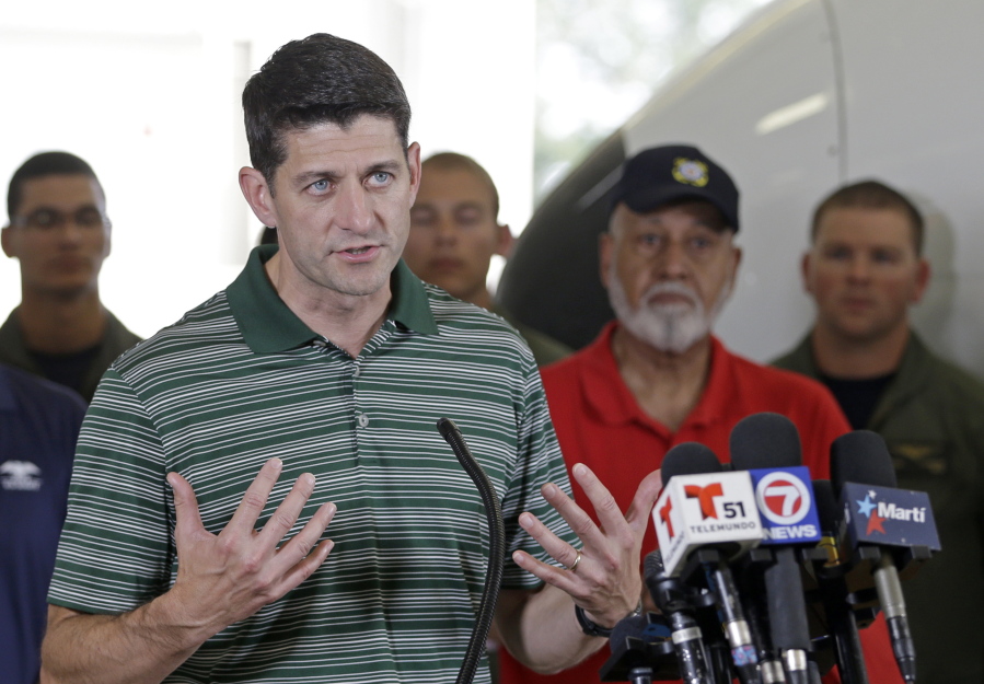 Speaker of the House Paul Ryan of Wisconsin talks to reporters Wednesday during a news briefing after assessing damage in the Florida Keys, at the Coast Guard Air Station Miami in Opa-locka, Fla.