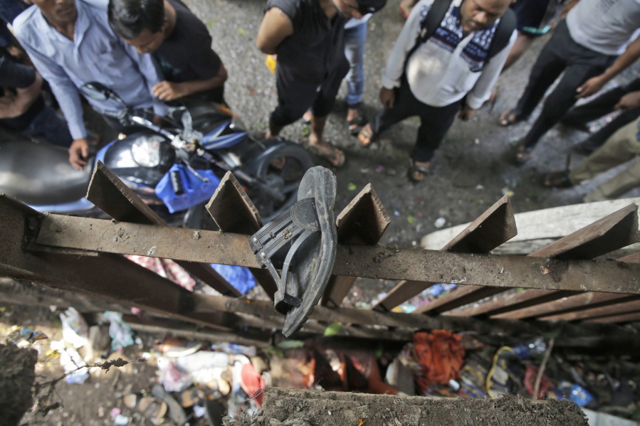 A slipper of an injured commuter is seen stuck on the railing of a pedestrian bridge where a stampede took place at the Elphinstone station, in Mumbai, India, on Friday. The stampede broke out on a crowded pedestrian bridge connecting two railway stations in Mumbai during the Friday morning rush, killing a number of people police said.