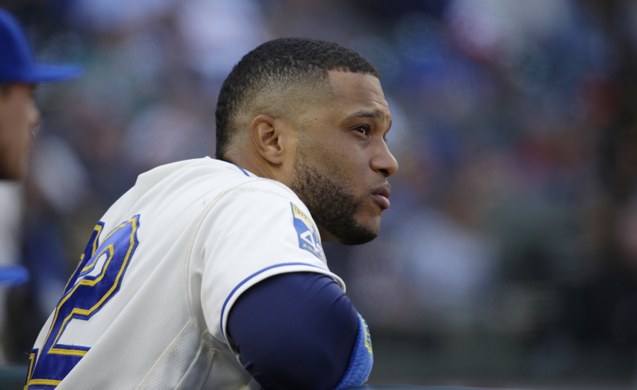 Seattle Mariners' Robinson Cano watches from the dugout during a baseball game against the Cleveland Indians, Sunday, Sept. 24, 2017, in Seattle. The game was the final home game of the season for the Mariners. (AP Photo/Ted S.