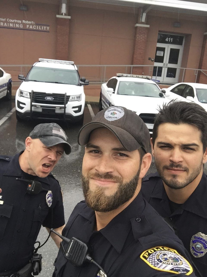In this photo provided by the Gainesville Police Department, officers, from left, John Nordman, Michael Hamill and Dan Rengering take a selfie in Gainesville, Fla. The photo was widely-shared on social media after the department posted it to Facebook with comments praising the officers good looks.