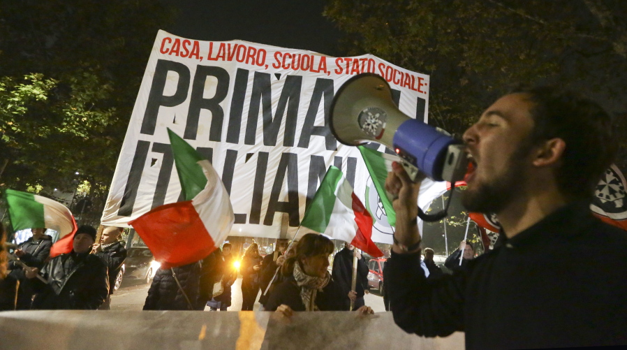 Neo-fascist CasaPound activists demonstrate outside the former Montello barracks, where migrants are being transferred by Milan’s prefecture, in Milan, Italy. Created as a social movement to help under-privileged Italians, a small neo-fascist group has been grabbing headlines and gaining notoriety with its sometimes violent opposition to migrants arriving in Italy. But CasaPound, which combines progressive policies such as gay rights and abortion with die-hard nationalism, is also attracting supporters across Italy.