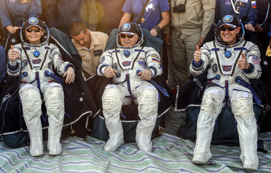 Russian cosmonaut Fyodor Yurchikhin, center, U.S. astronauts Peggy Whitson, left, and Jack Fischer, right, pose for a photo after landing in a remote area outside the town of Dzhezkazgan, Kazakhstan, Sunday. The Soyuz capsule carrying Astronauts Peggy Whitson and Jack Fischer of NASA and Fyodor Yurchikhin of the Russian space agency Roscosmos safely returned to Earth in the Kazakh steppe.